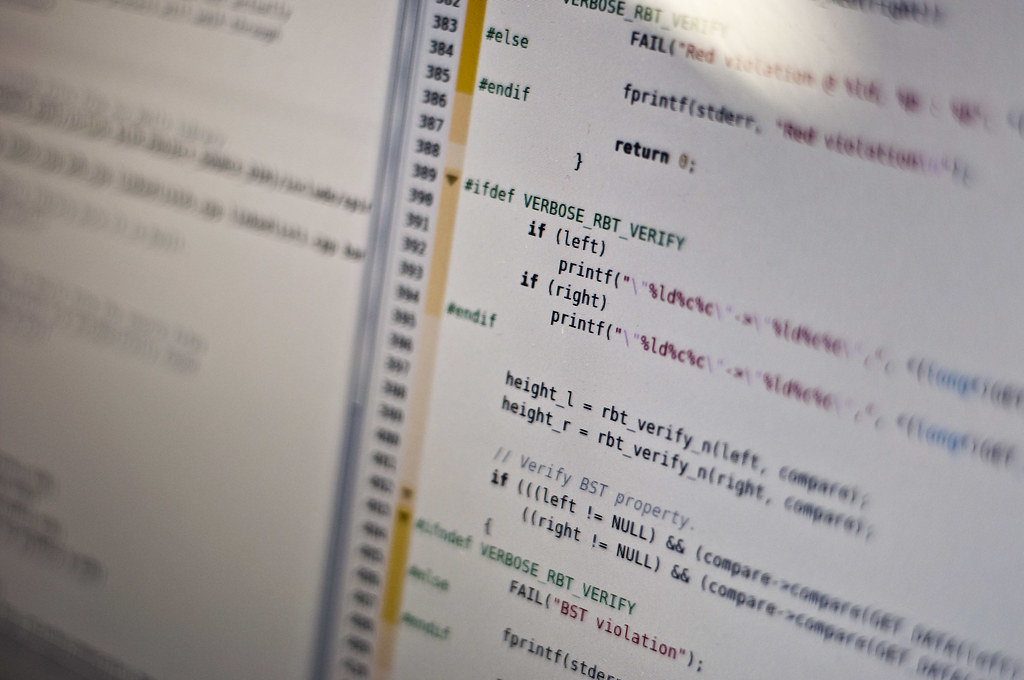Close-up of C source code on a monitor, including fprintf calls that write to stderr